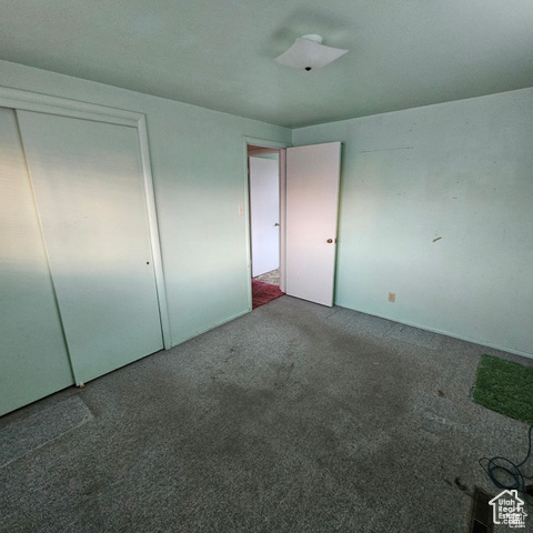 Unfurnished bedroom with carpet floors and a closet