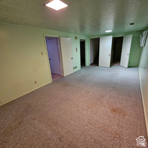 Unfurnished room featuring light carpet