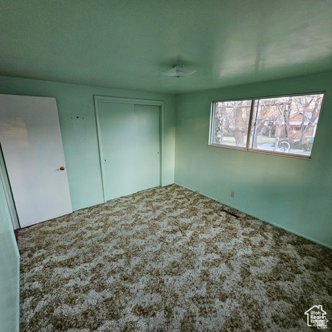 Unfurnished bedroom with carpet floors and a closet