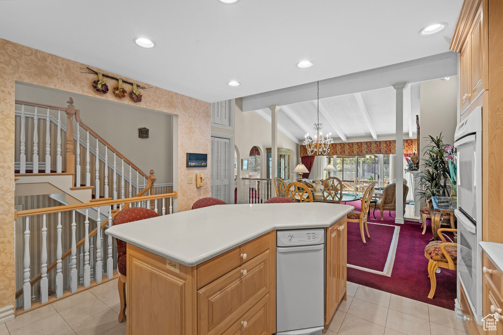 Kitchen featuring wallpapered walls, light tile patterned floors, recessed lighting, light countertops, and a kitchen bar