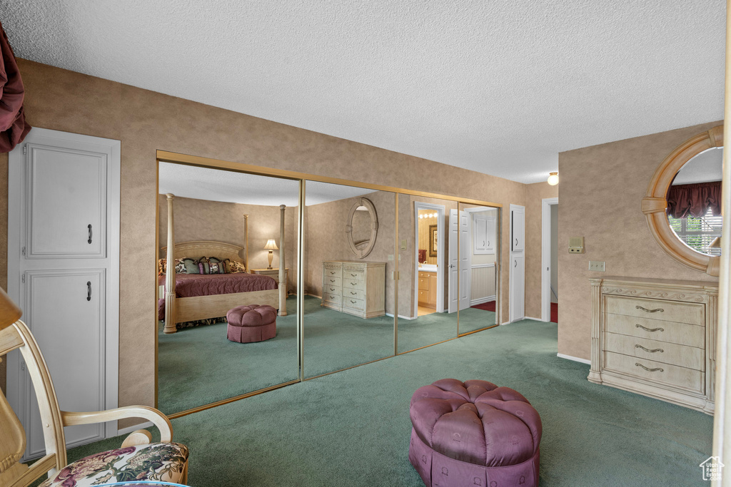 Carpeted bedroom featuring a textured ceiling