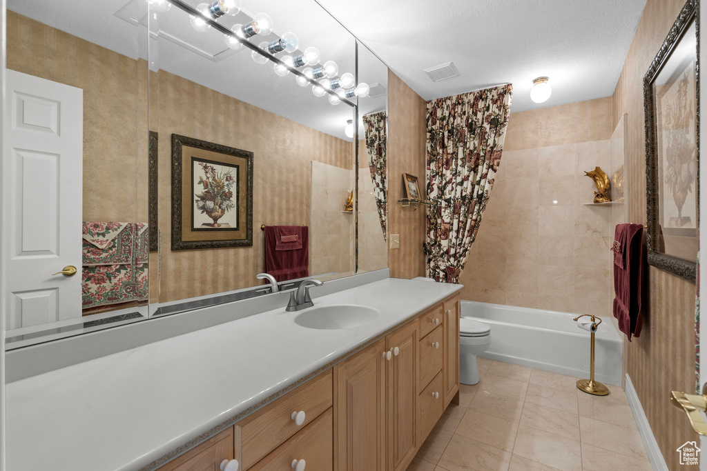 Bathroom with vanity, toilet, and shower / washtub combination