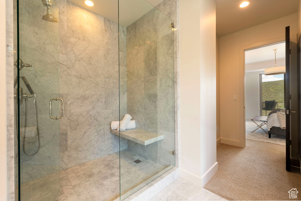 Ensuite bathroom featuring a stall shower, baseboards, and recessed lighting