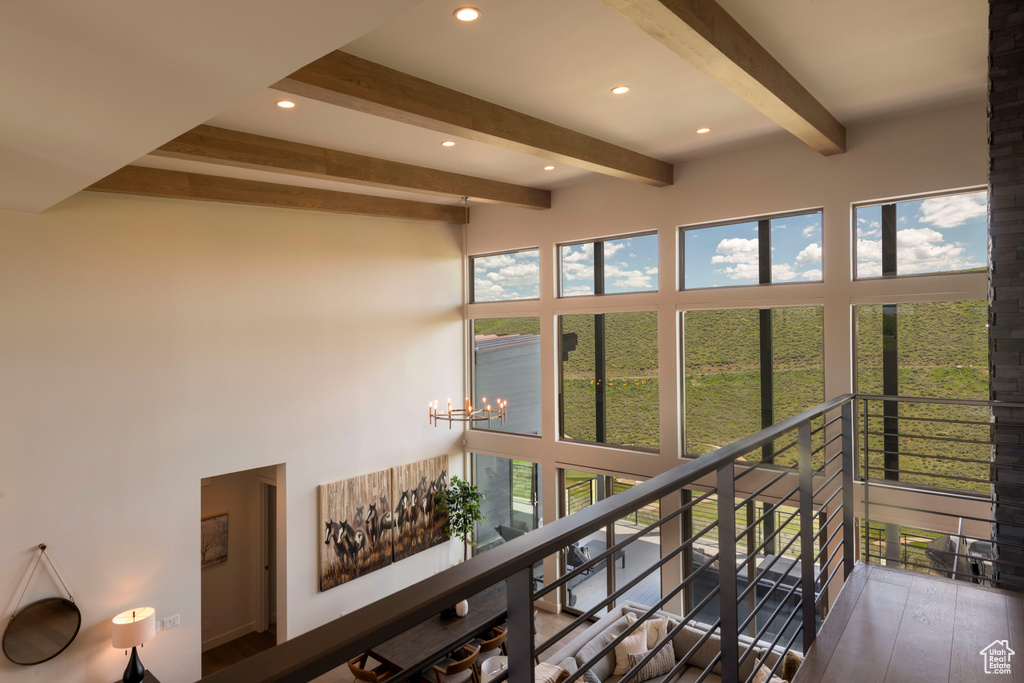 Sunroom with beam ceiling and a chandelier