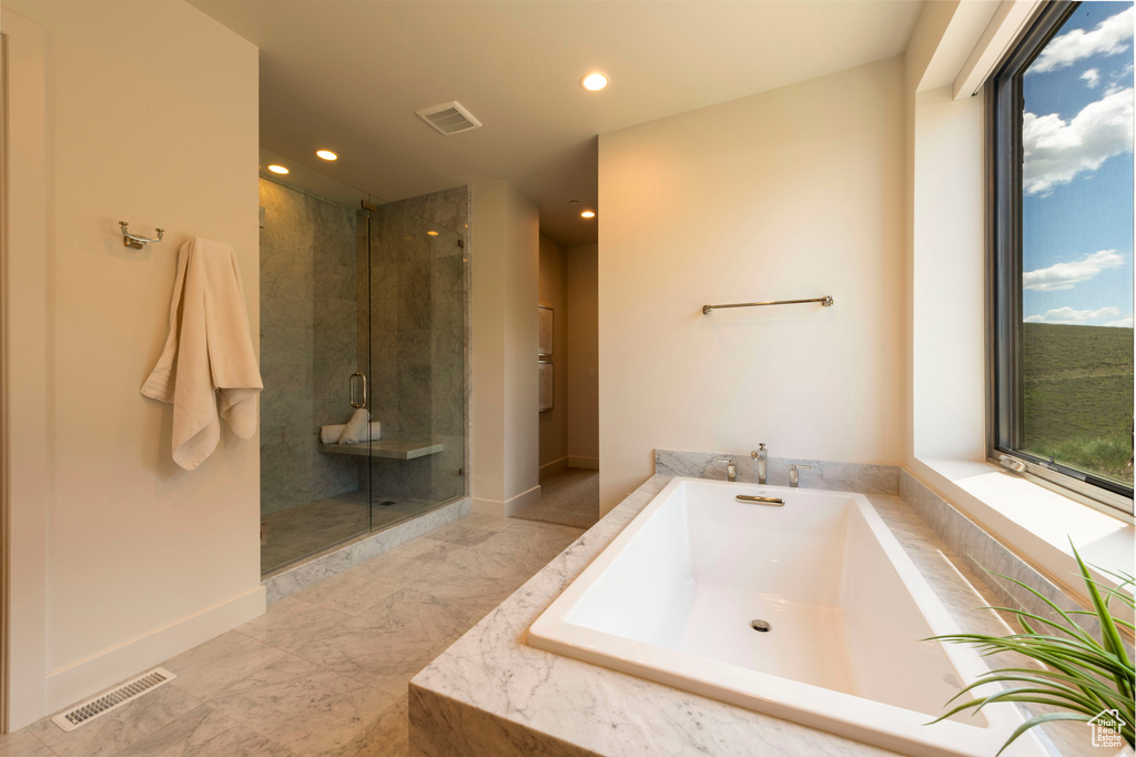 Bathroom with a shower stall, a garden tub, marble finish floors, recessed lighting, and baseboards
