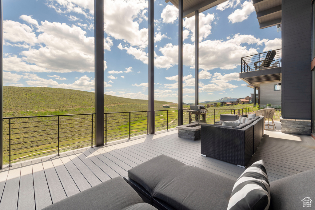Deck featuring an outdoor hangout area and a rural view