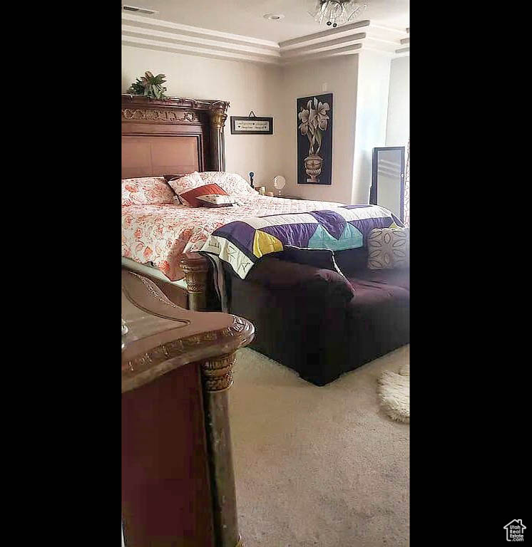Carpeted bedroom featuring crown molding