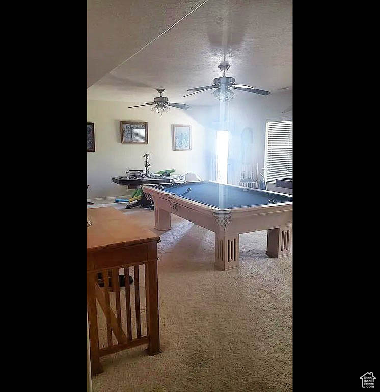 Recreation room with a ceiling fan, billiards table, and carpet flooring