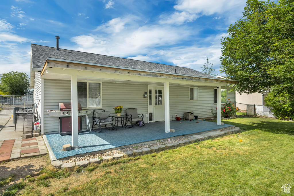 Rear view of property with a shingled roof