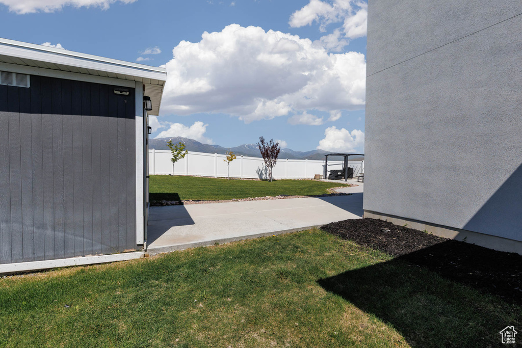 View of yard with a mountain view and a patio