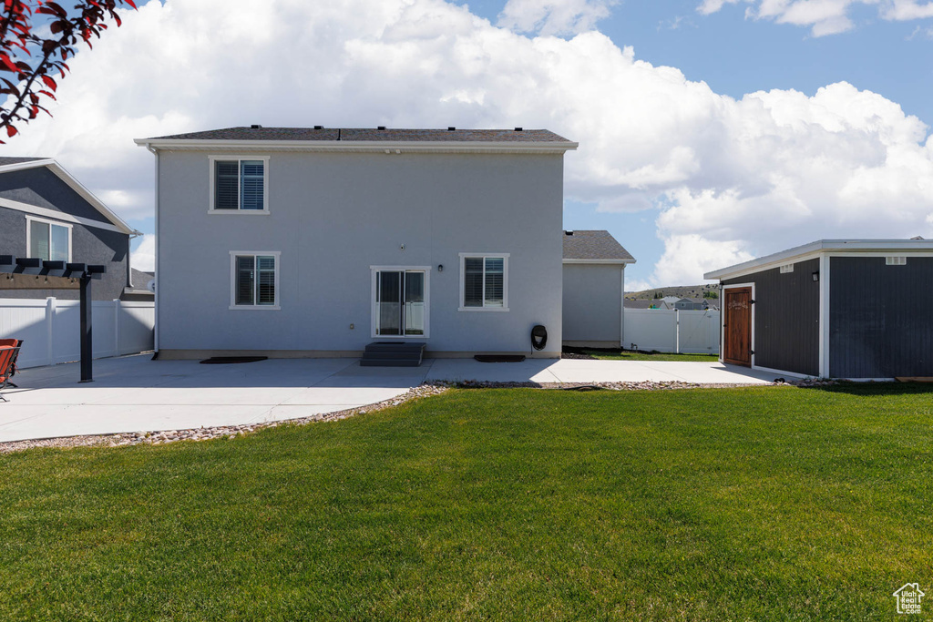 Rear view of property with a patio area, entry steps, and stucco siding