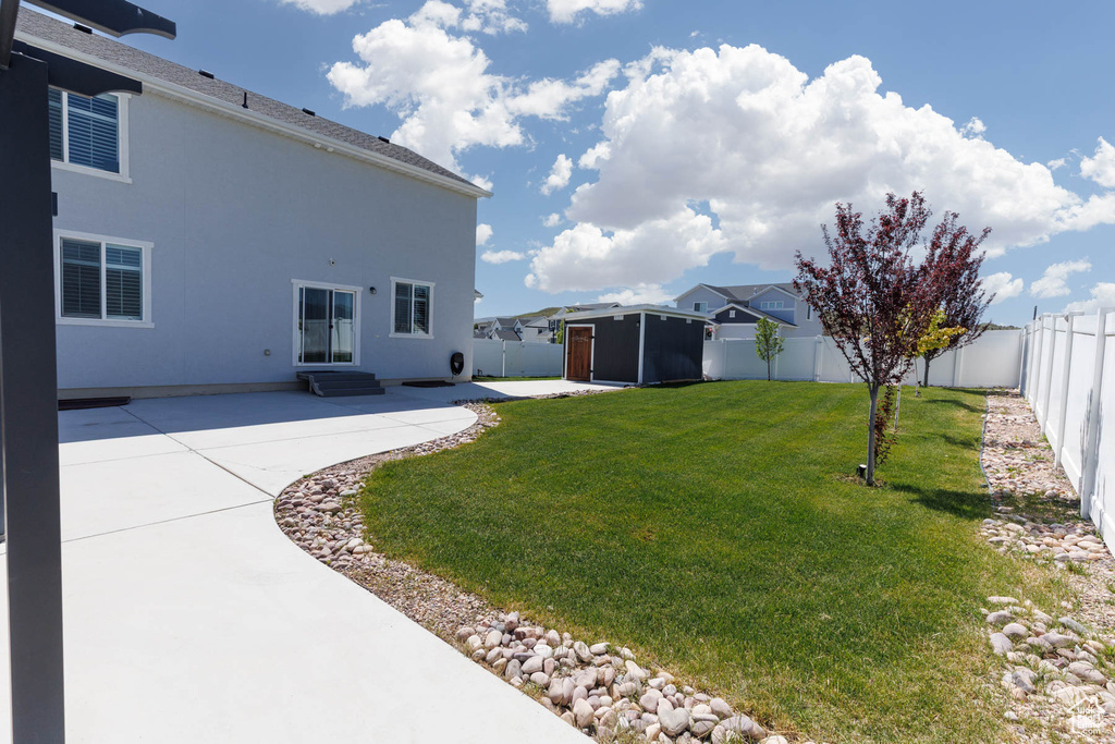 View of yard with a patio and entry steps