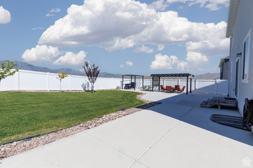 View of patio with a pergola and a mountain view