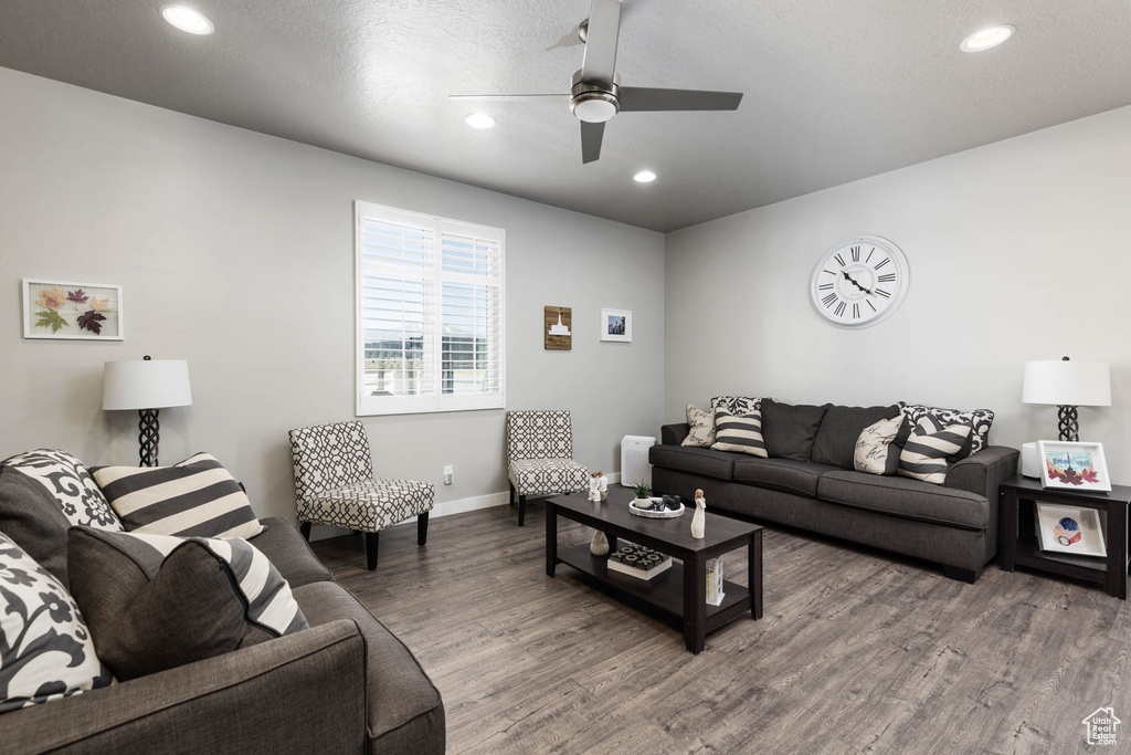 Living area featuring wood finished floors, baseboards, recessed lighting, and ceiling fan