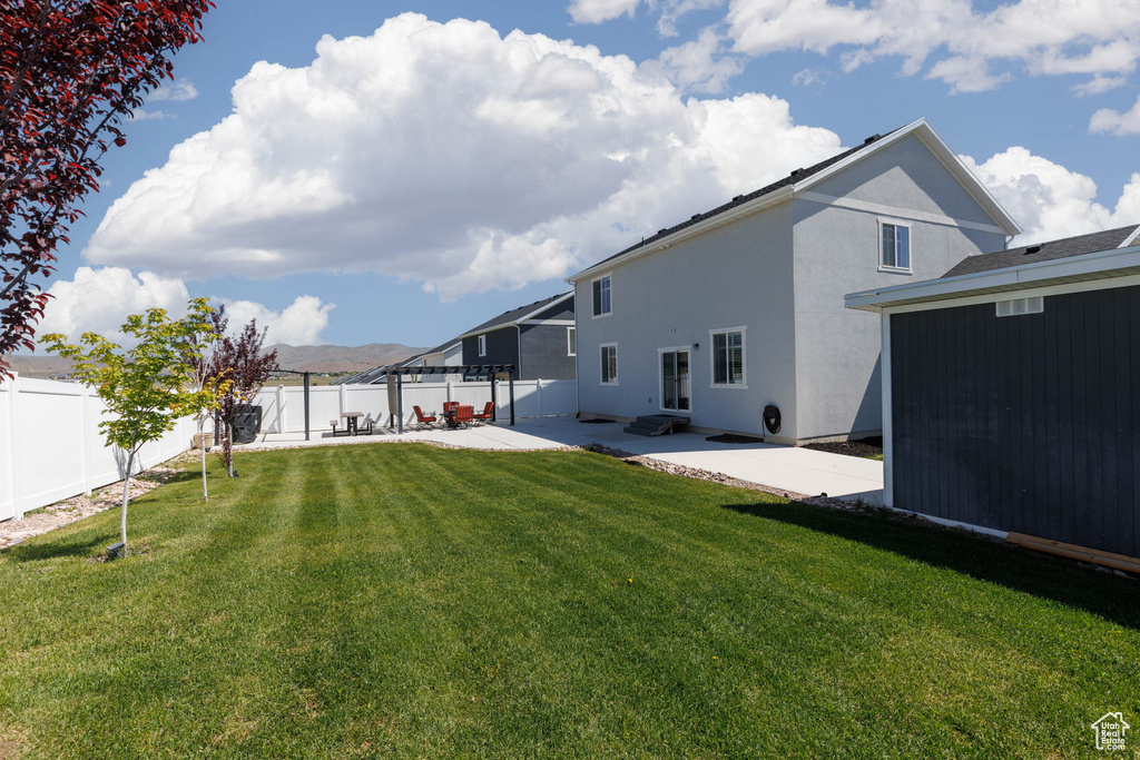 Rear view of property featuring a patio area and stucco siding