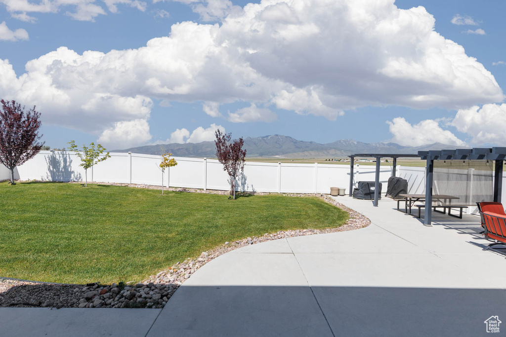 View of yard featuring a patio area and a mountain view