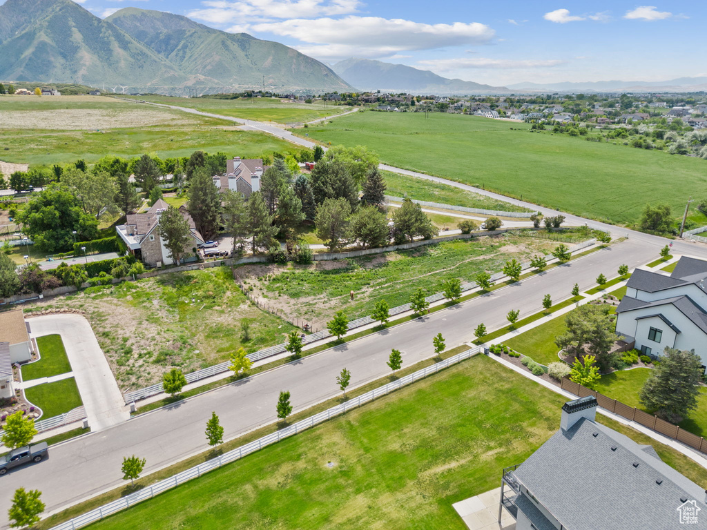 Aerial view of sparsely populated area featuring a mountain backdrop and nearby suburban area