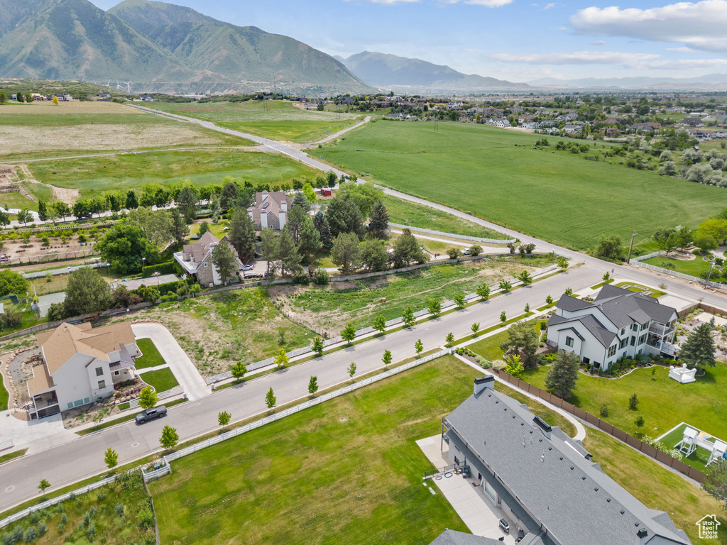 Aerial view of sparsely populated area featuring a mountain backdrop and nearby suburban area