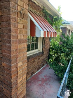 View of side of property featuring brick siding