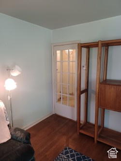 Unfurnished room featuring dark wood-type flooring and baseboards