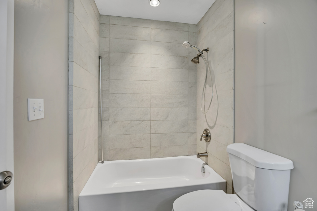 Bathroom featuring toilet and shower / bath combination