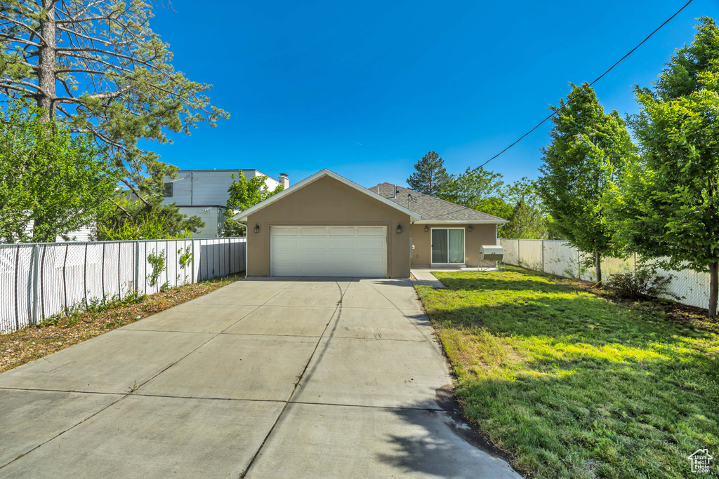 Ranch-style house featuring stucco siding, an attached garage, and concrete driveway
