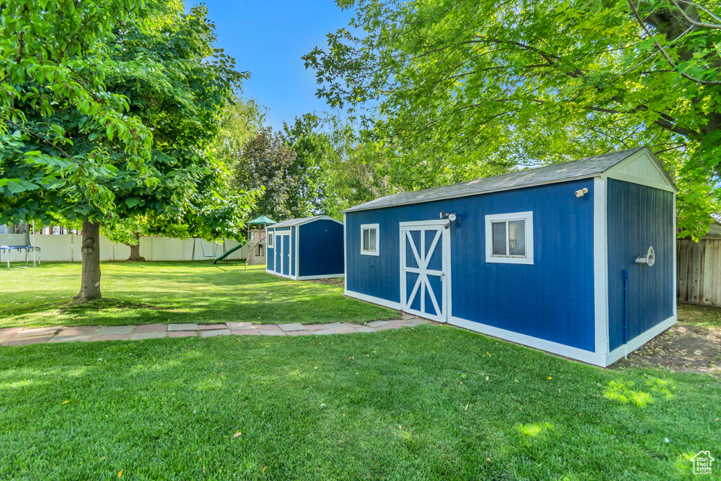 View of shed featuring a playground and a trampoline
