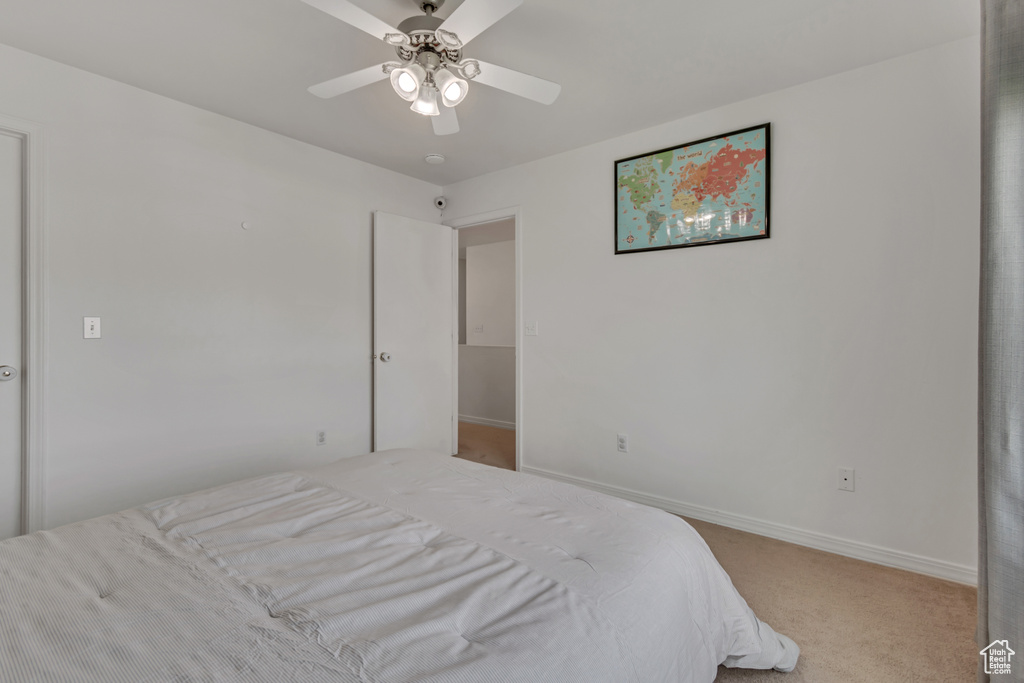 Bedroom with carpet, baseboards, and ceiling fan
