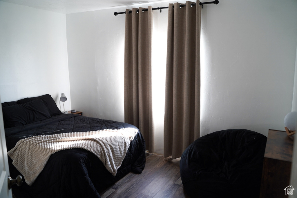 Bedroom with dark wood-type flooring