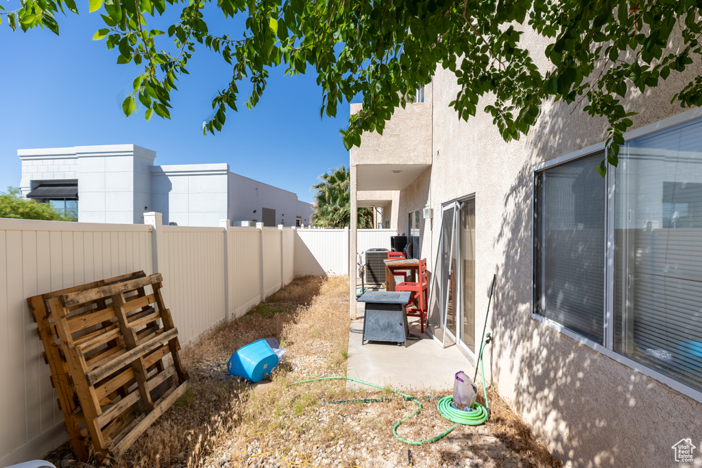 Fenced backyard featuring central AC unit
