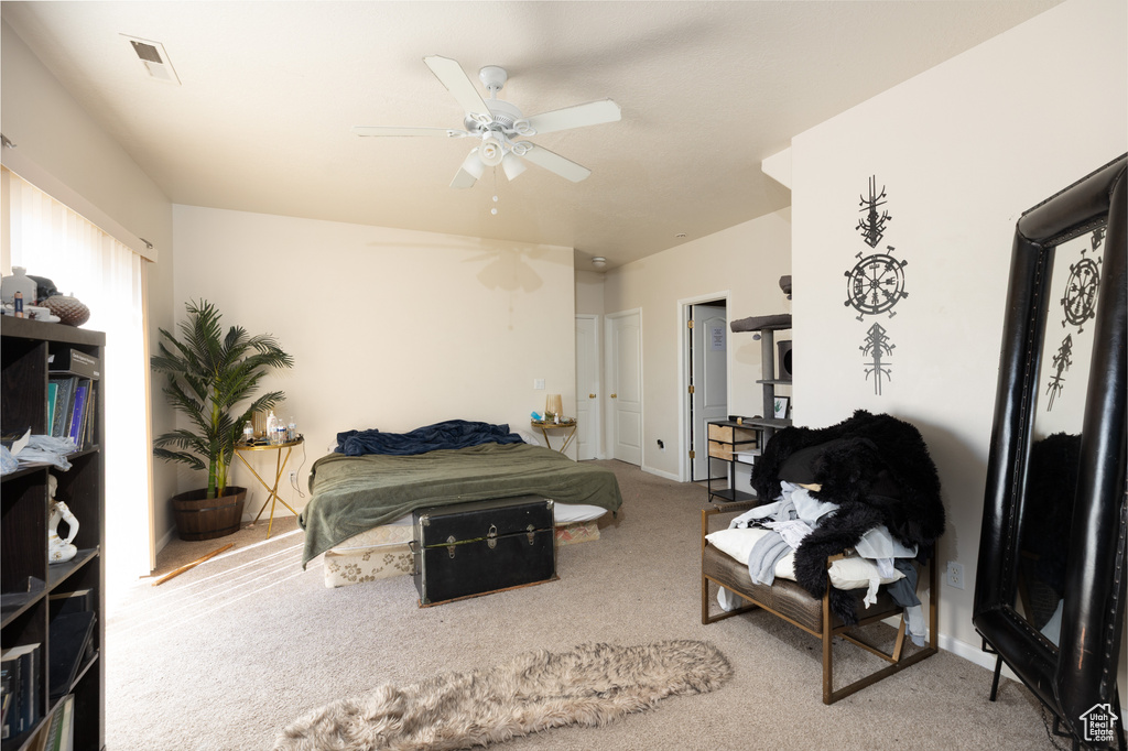 Carpeted bedroom with ceiling fan