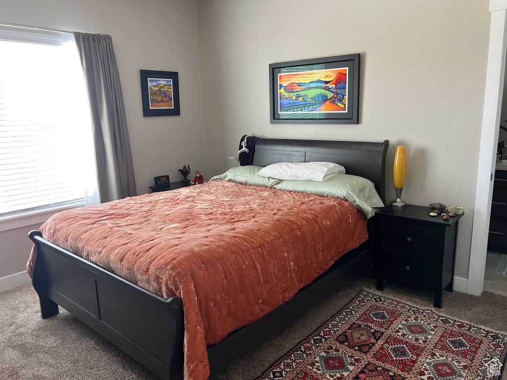 Carpeted bedroom featuring baseboards