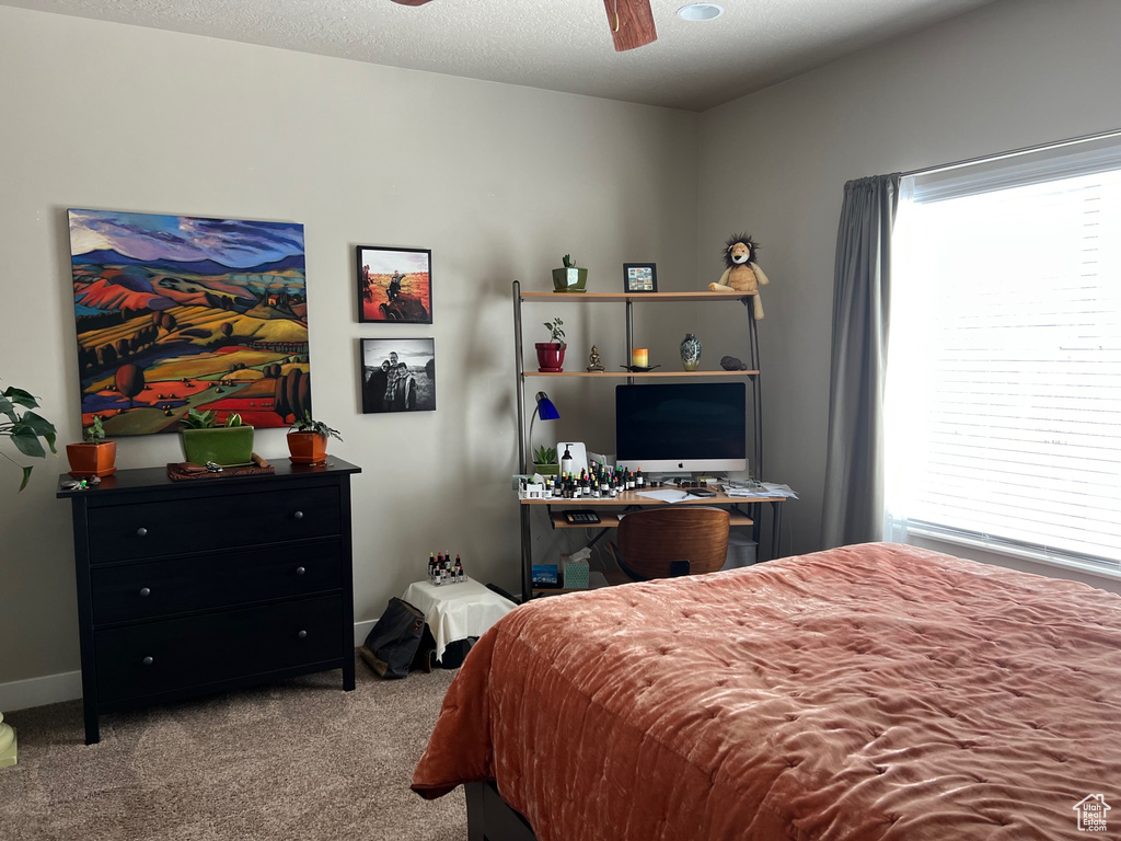 Bedroom featuring carpet flooring, baseboards, and a ceiling fan