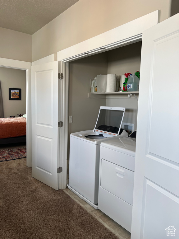 Washroom featuring independent washer and dryer and light carpet