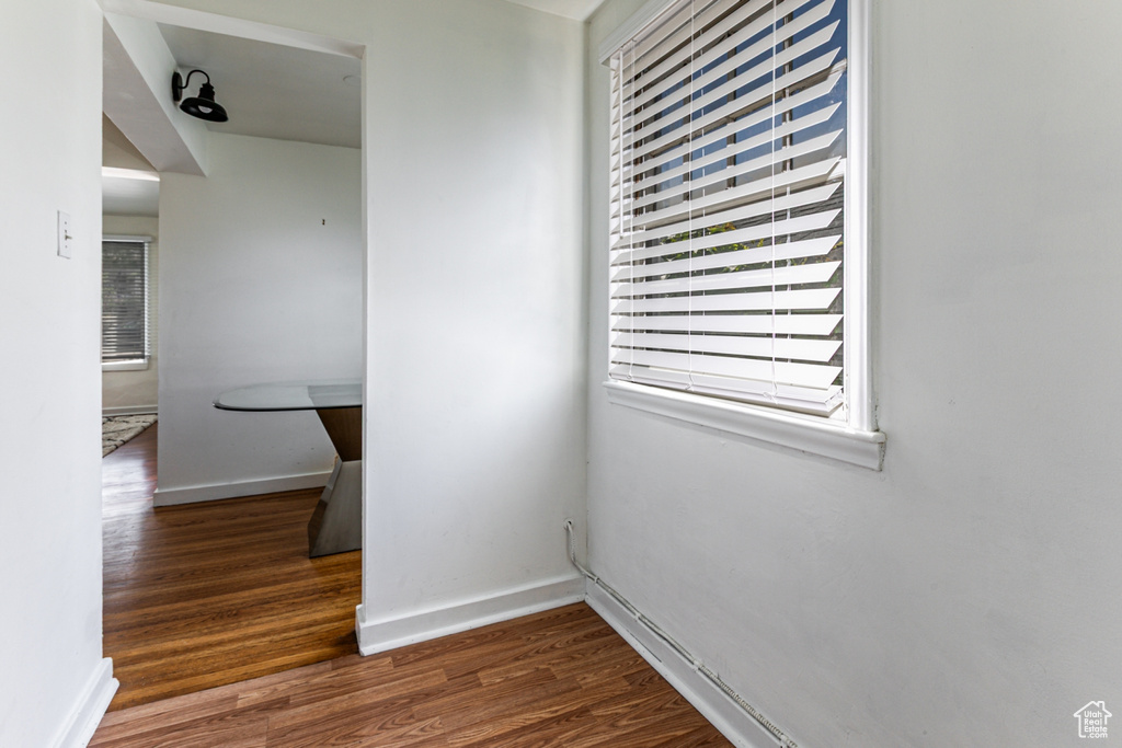 Corridor featuring wood finished floors and baseboards
