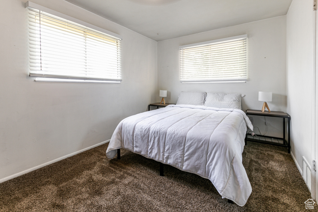 Bedroom featuring carpet flooring and baseboards