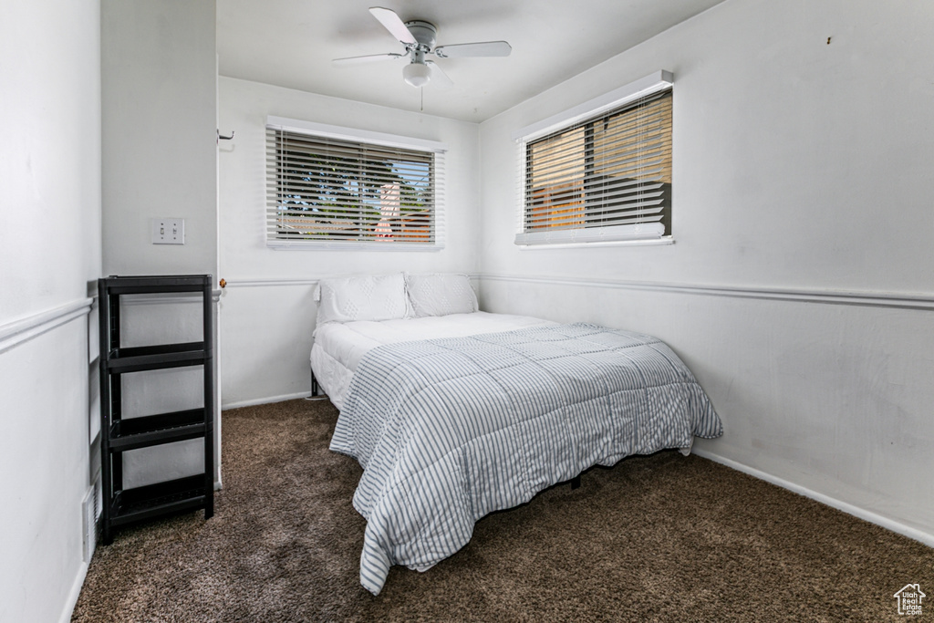 Bedroom with carpet floors, a ceiling fan, and baseboards