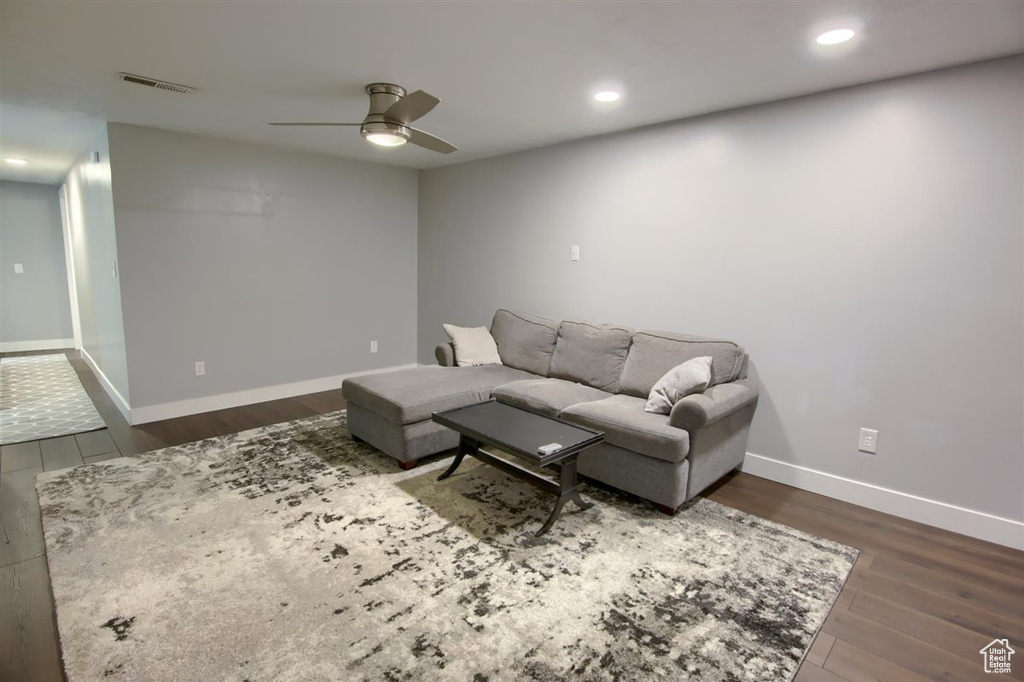 Living room featuring a ceiling fan, dark wood finished floors, recessed lighting, and baseboards