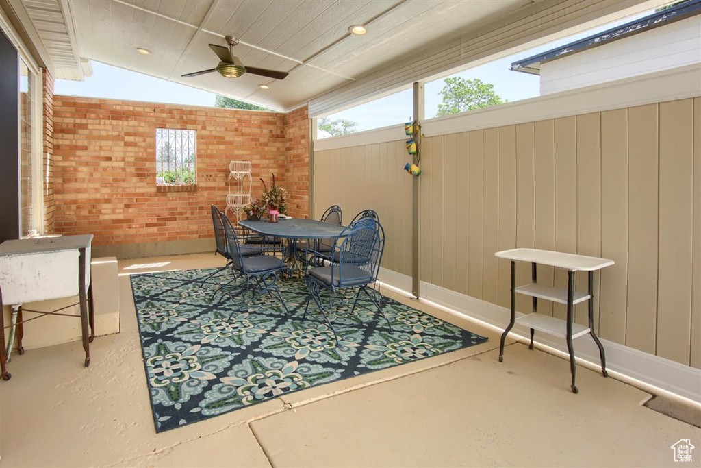 View of patio with outdoor dining space and ceiling fan