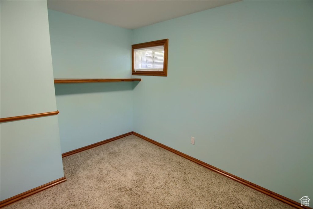 Carpeted empty room with baseboards