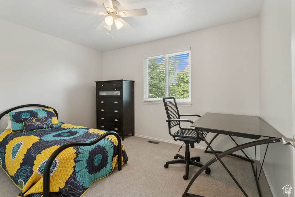Carpeted bedroom with baseboards and a ceiling fan