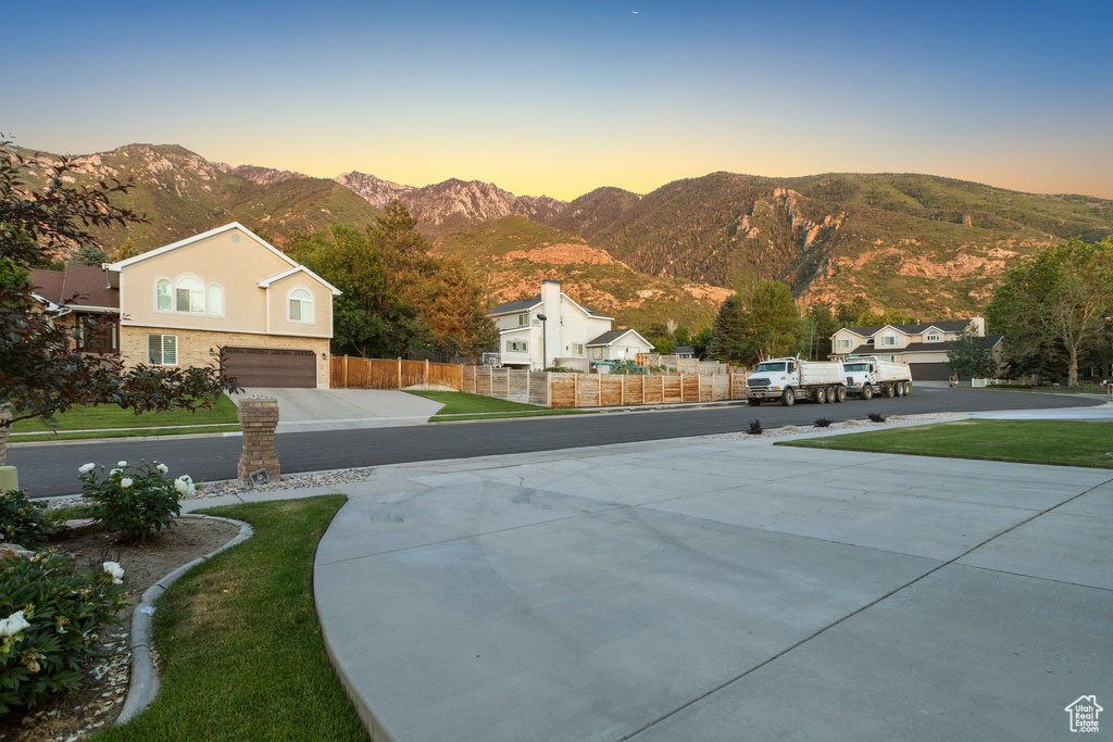 View of property's community with a mountain view and an attached garage