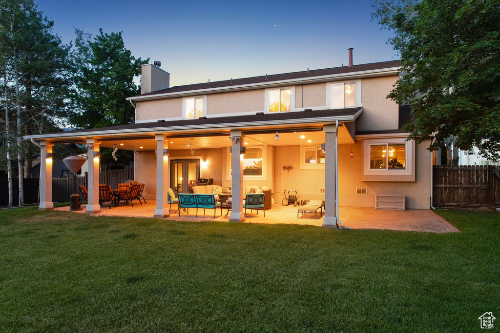 Rear view of property with a chimney, stucco siding, an outdoor living space, and a patio area