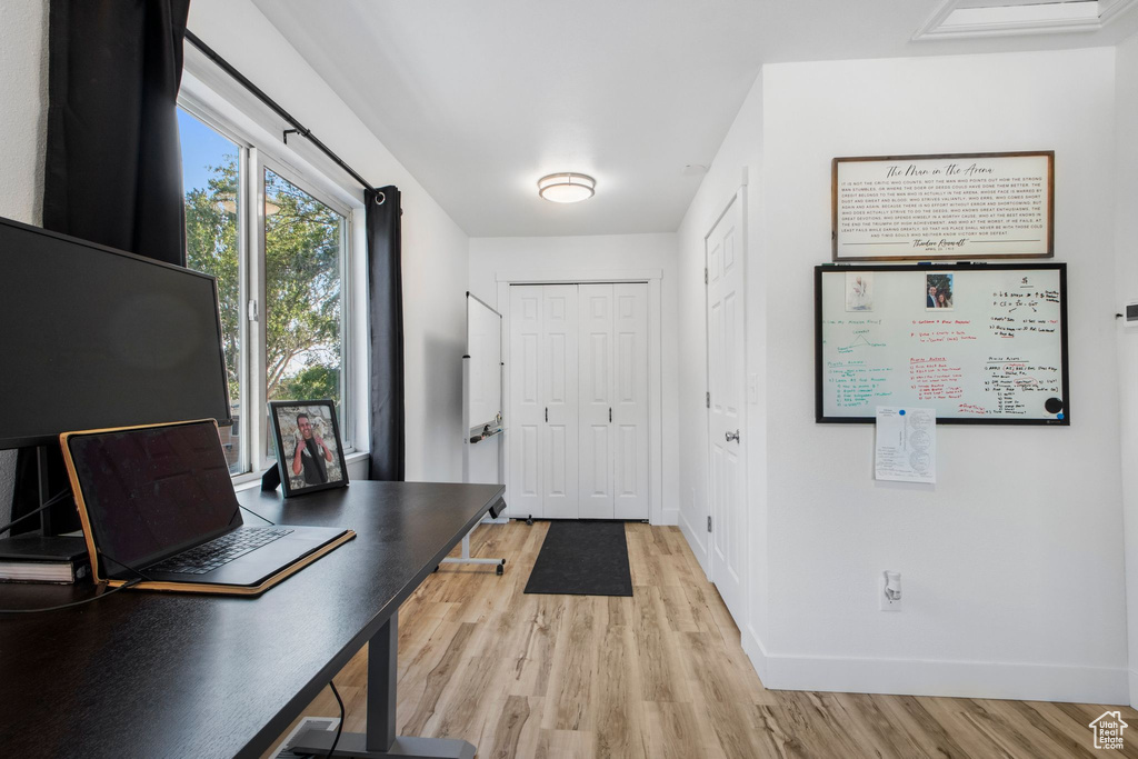 Foyer entrance featuring light wood-style flooring and baseboards