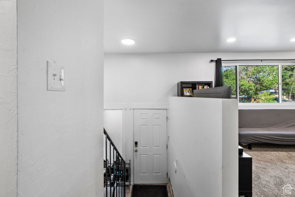 Stairs with carpet and recessed lighting
