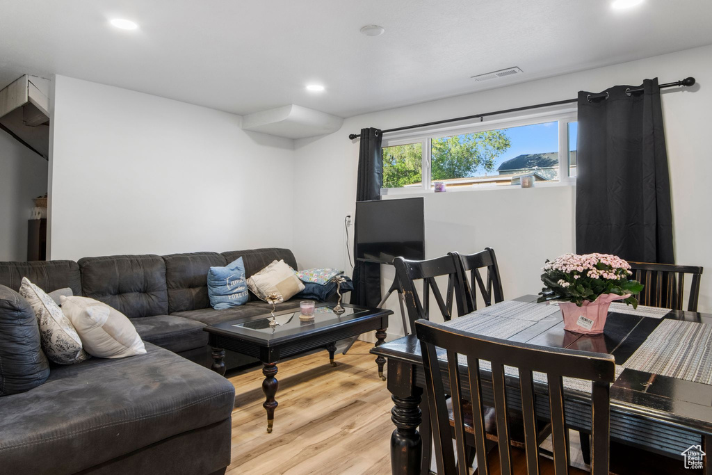 Living area with wood finished floors and recessed lighting