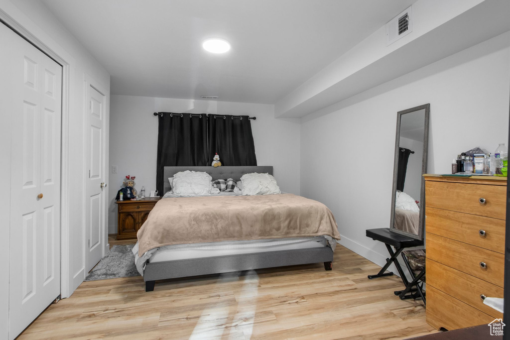 Bedroom featuring light wood-style floors and baseboards