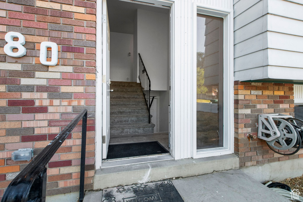 Doorway to property with brick siding