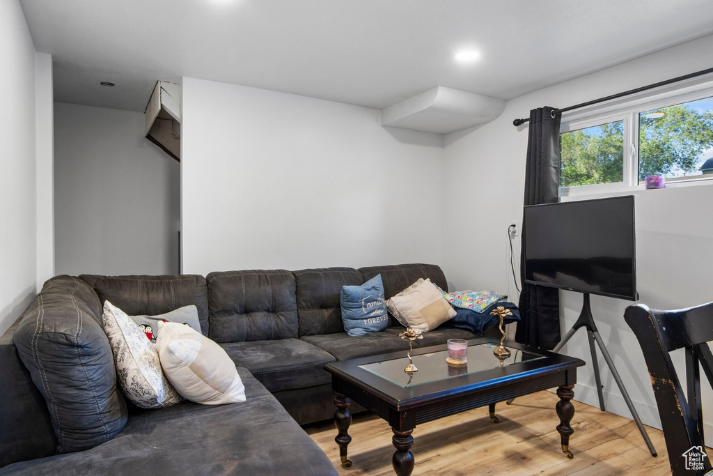Living area with wood finished floors and recessed lighting