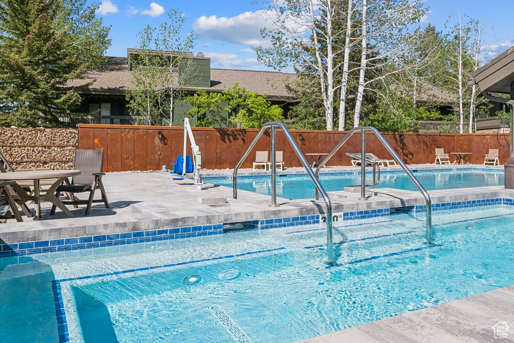 Community pool featuring a patio